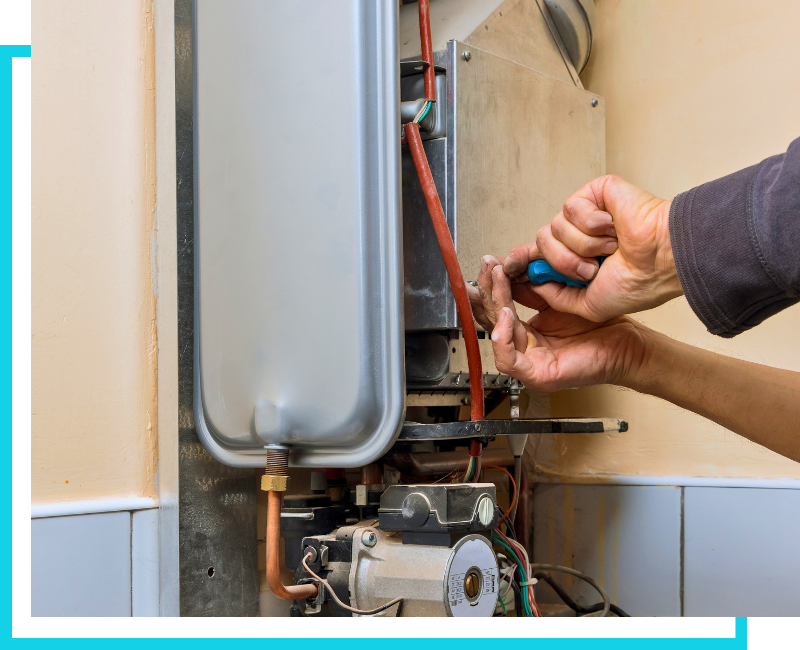 Technician servicing the internal components of a water heater